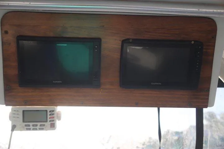 Slide: The Image of Dashboard of a 2000 Luhrs Tournament 290 Open with Garmin displays. - 14
