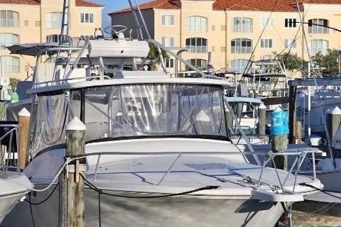 Slide: The Image of 2000 Luhrs Tournament 290 Open boat docked at marina with buildings in background. - 2