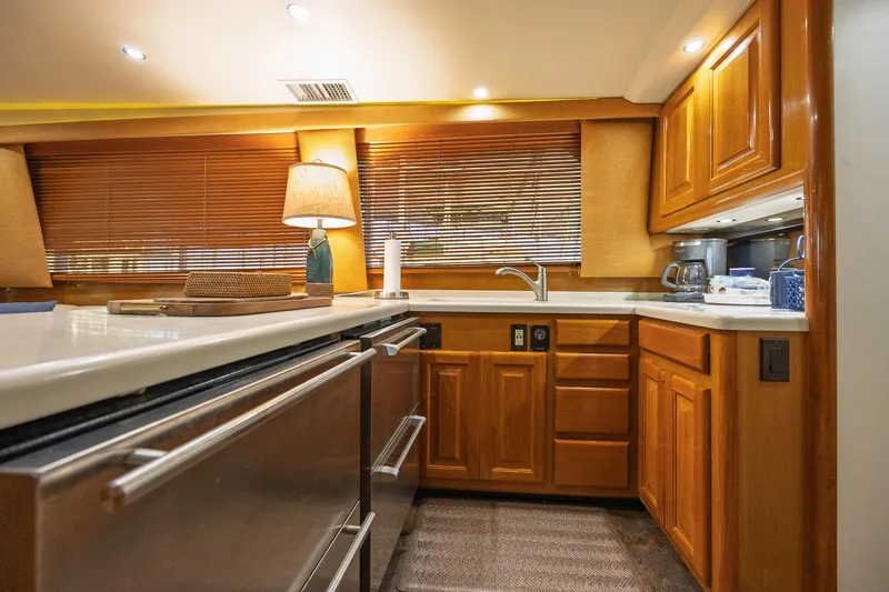 Slide: The Image of Luxurious kitchen interior of 1998 Viking 50 Convertible yacht with wooden cabinetry. - 10