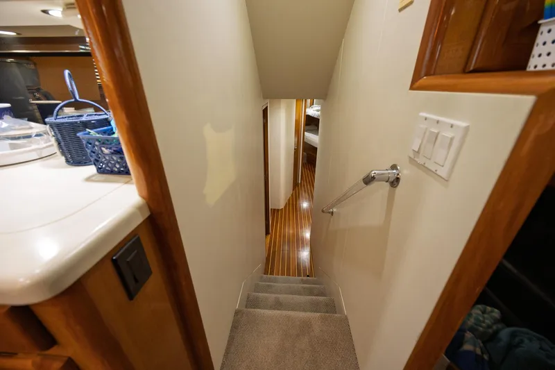 Slide: The Image of Interior view of 1998 Viking 50 Convertible yacht, featuring stairs and polished wood flooring. - 12