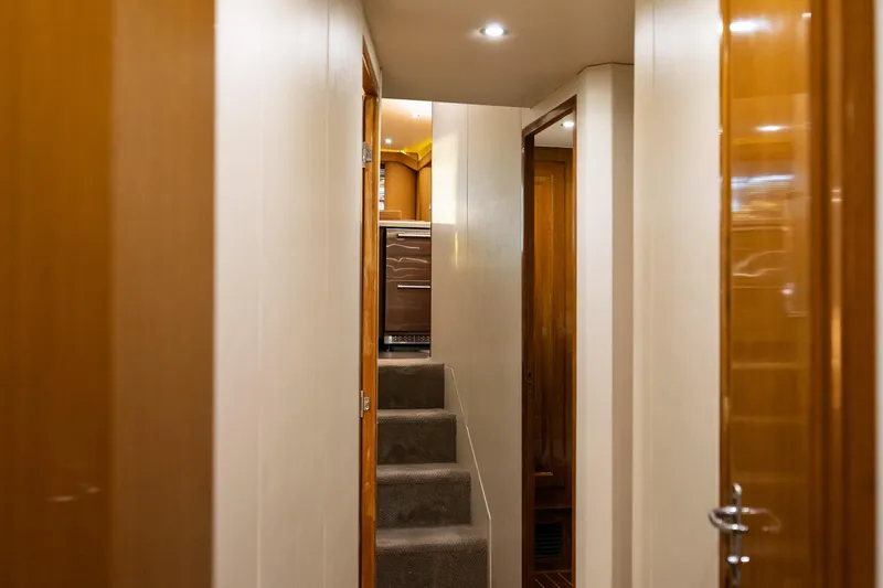 Slide: The Image of Interior hallway of a 1998 Viking 50 Convertible yacht with wooden finishes. - 13