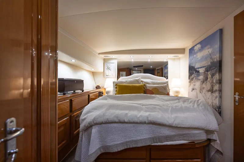Slide: The Image of Luxurious bedroom interior of a 1998 Viking 50 Convertible yacht with cozy bedding. - 16