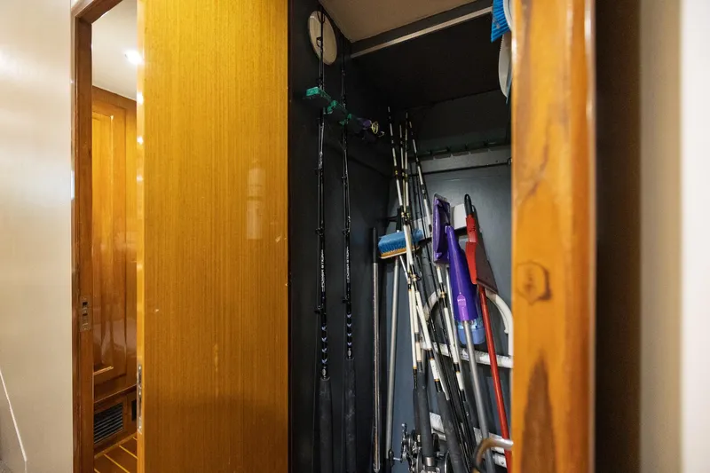 Slide: The Image of Storage closet on a 1998 Viking 50 Convertible yacht with fishing rods and cleaning tools. - 17