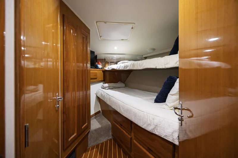 Slide: The Image of Interior of 1998 Viking 50 Convertible yacht with wooden cabinets and bunk beds. - 19