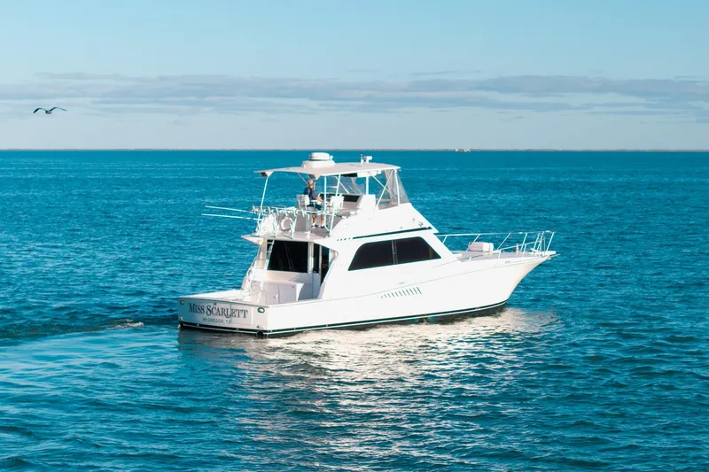 Slide: The Image of 1998 Viking 50 Convertible yacht cruising on open blue waters. - 2