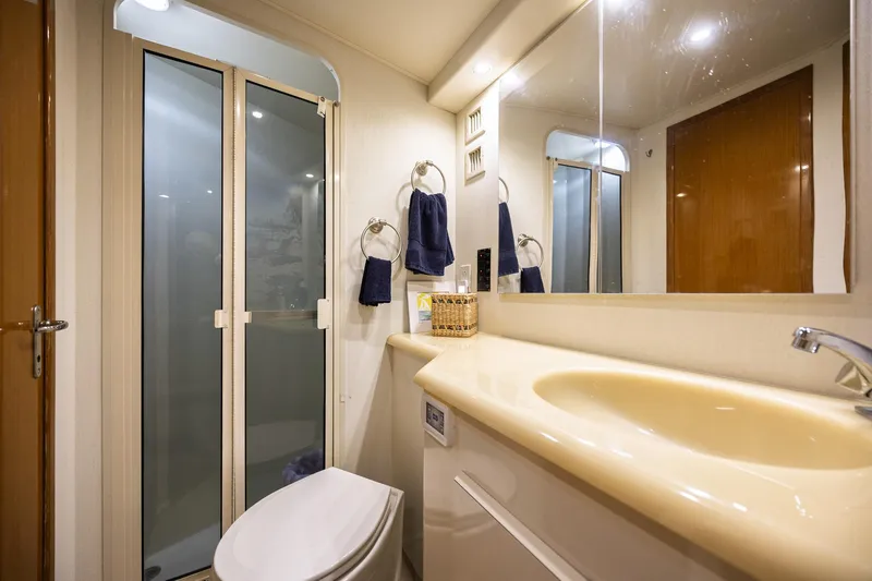 Slide: The Image of Bathroom interior of 1998 Viking 50 Convertible yacht with shower, sink, and mirror. - 20