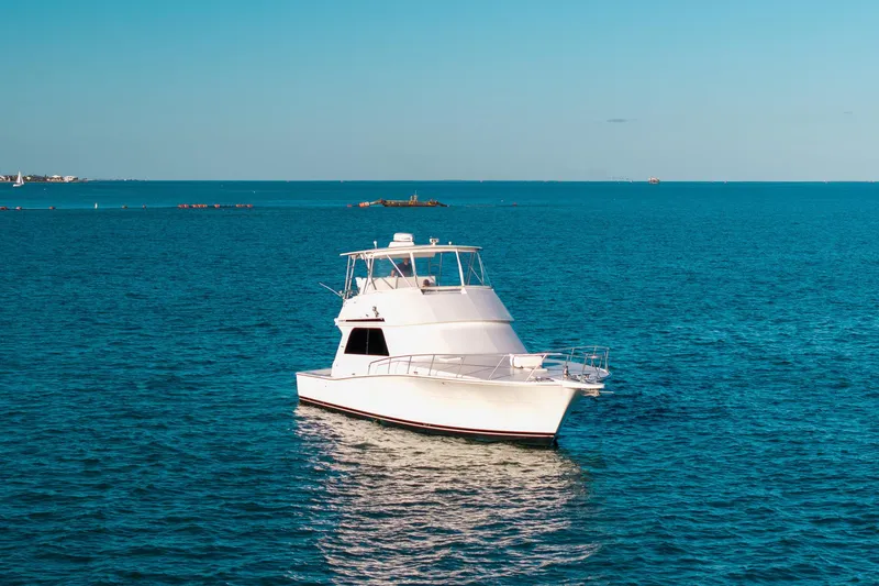 Slide: The Image of A 1998 Viking 50 Convertible yacht on calm blue ocean waters. - 21
