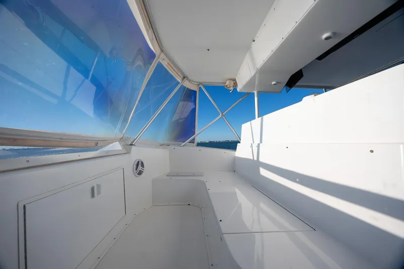 Slide: The Image of Interior view of a 1998 Viking 50 Convertible yacht with blue-tinted windows. - 24