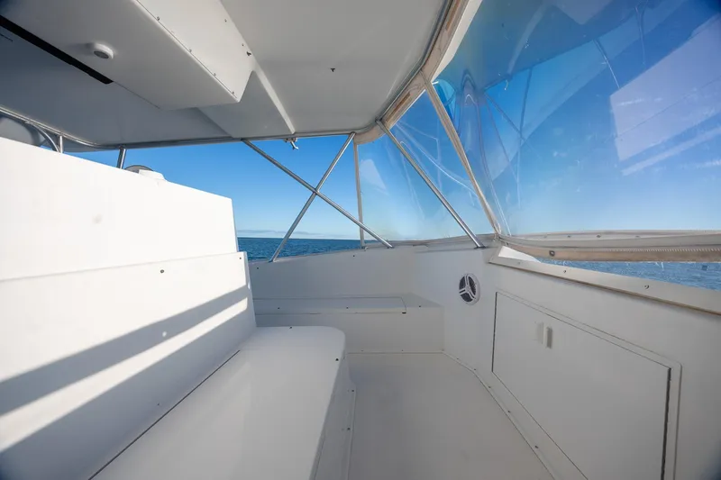 Slide: The Image of Interior view of a 1998 Viking 50 Convertible yacht, showcasing spacious seating and ocean view. - 26
