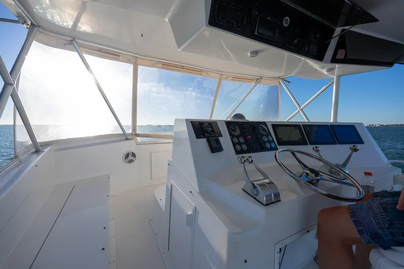 Slide: The Image of Helm of 1998 Viking 50 Convertible yacht with steering wheel and control panels. - 27