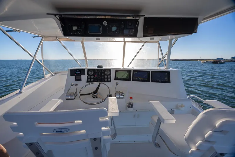 Slide: The Image of Cockpit view of 1998 Viking 50 Convertible yacht with ocean backdrop. - 29