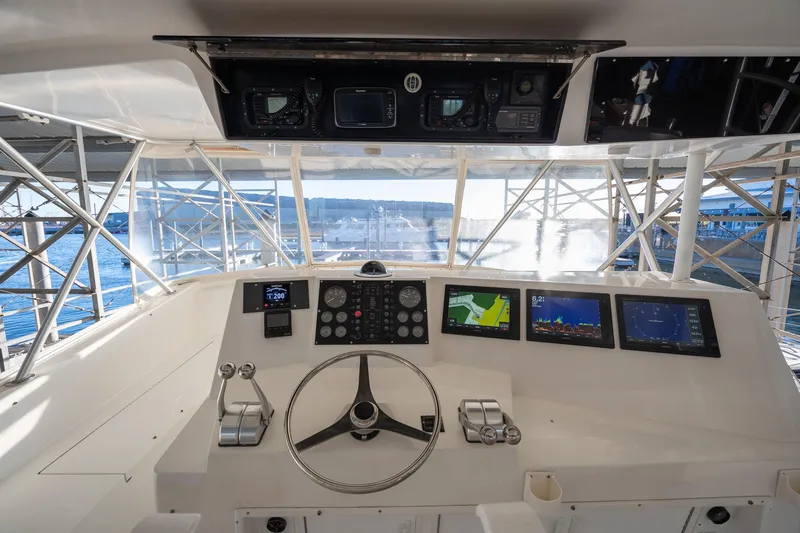 Slide: The Image of Cockpit of a 1998 Viking 50 Convertible yacht with navigation screens and steering wheel. - 30
