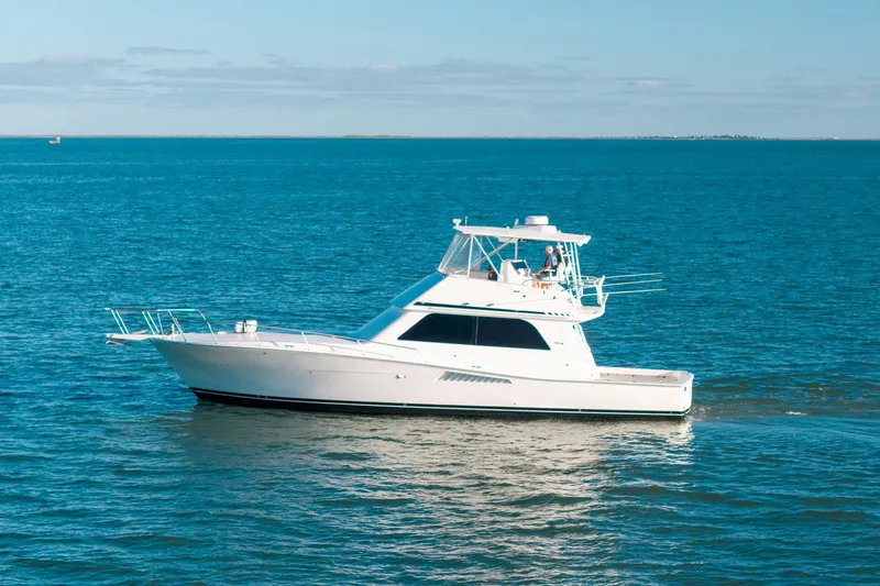 Slide: The Image of 1998 Viking 50 Convertible yacht cruising on open blue waters. - 4