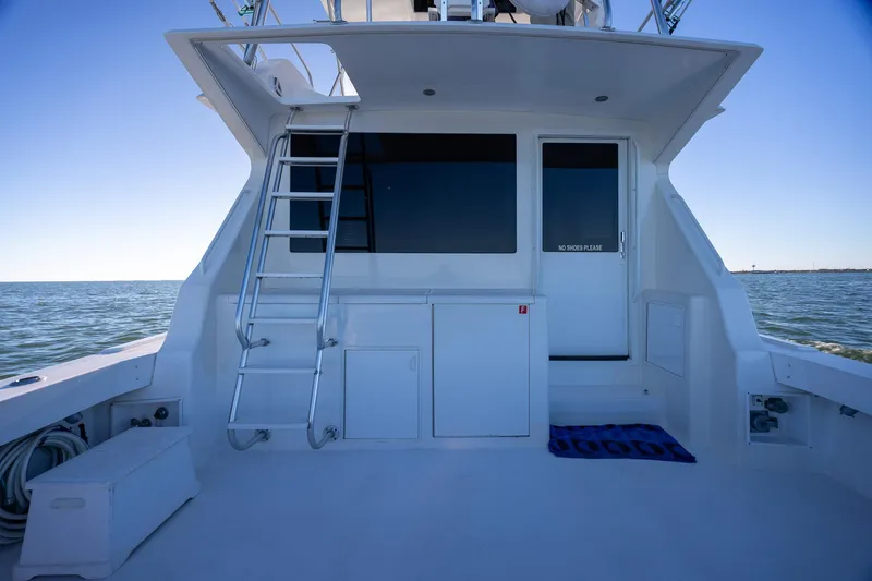 Slide: The Image of 1998 Viking 50 Convertible yacht deck with ladder and ocean view. - 40