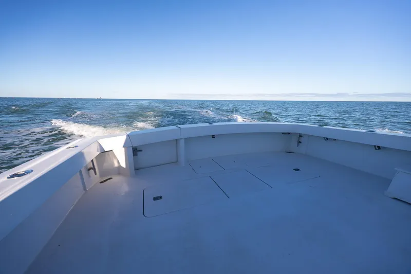 Slide: The Image of 1998 Viking 50 Convertible yacht deck with ocean view under clear blue sky. - 42