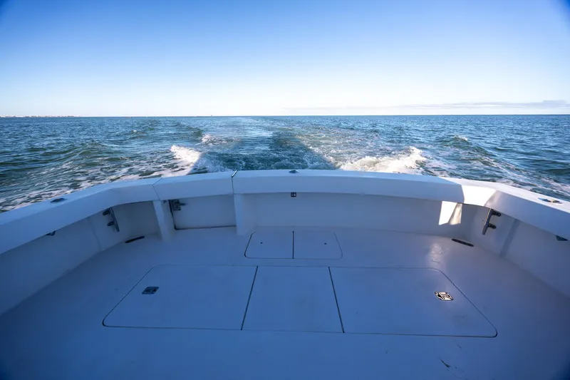Slide: The Image of Stern view of 1998 Viking 50 Convertible yacht cruising on open water. - 43