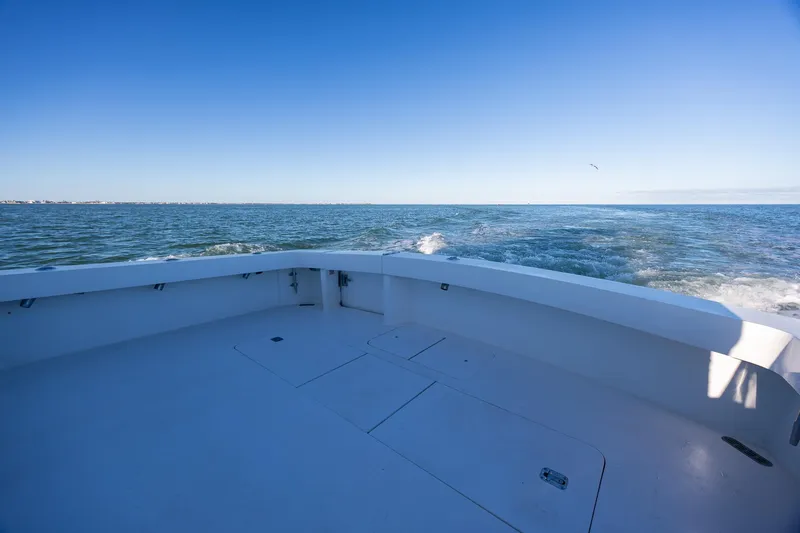 Slide: The Image of 1998 Viking 50 Convertible boat deck with ocean view under clear blue sky. - 44