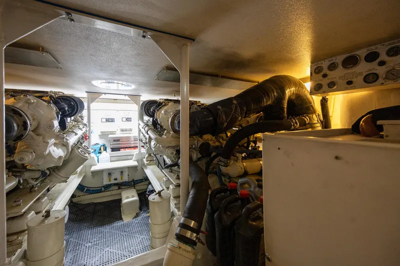 Slide: The Image of Engine room of a 1998 Viking 50 Convertible yacht, showcasing dual engines and control panels. - 46