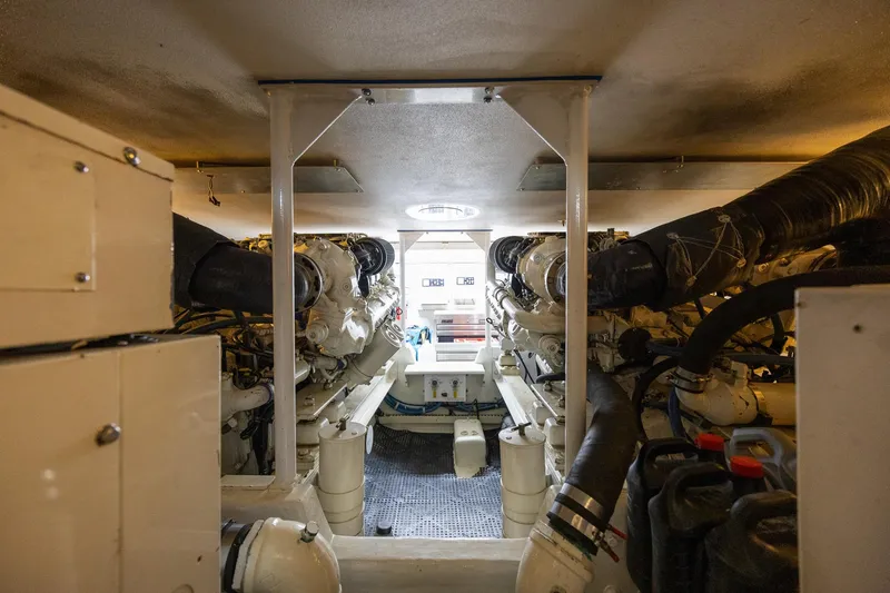 Slide: The Image of Engine room of a 1998 Viking 50 Convertible yacht, showcasing dual engines and mechanical components. - 47