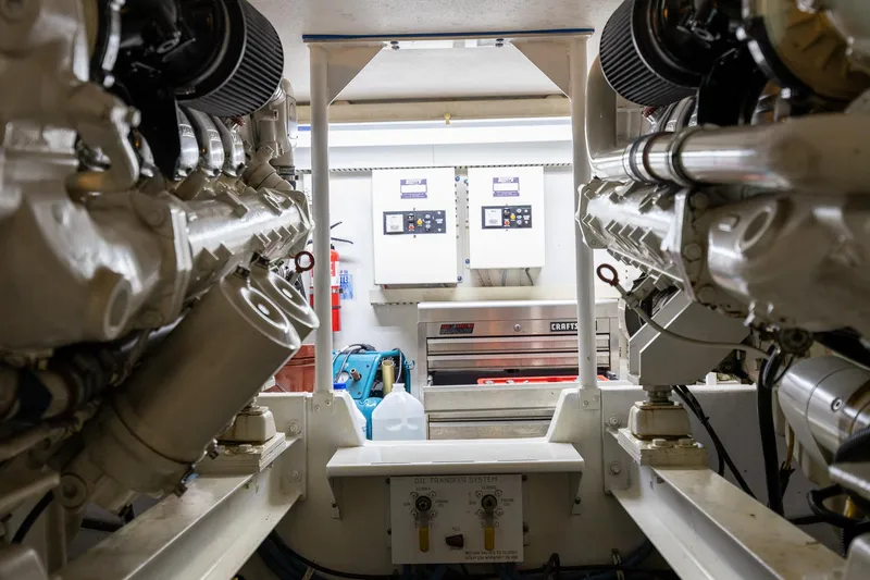 Slide: The Image of Engine room of a 1998 Viking 50 Convertible yacht, showcasing dual engines and control panels. - 50