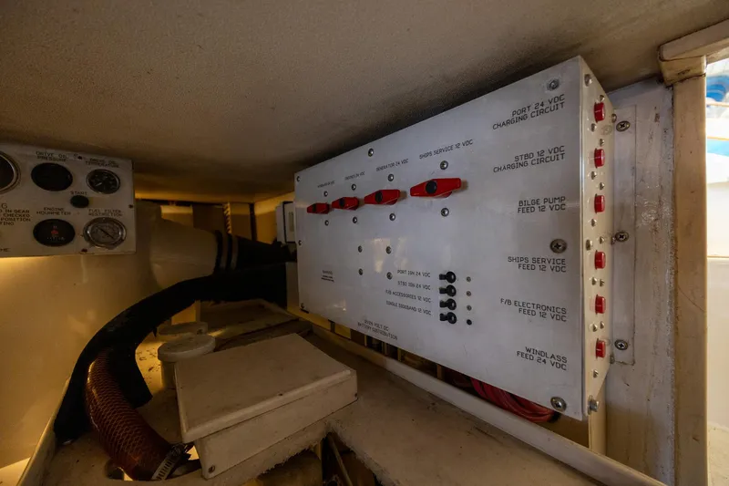 Slide: The Image of Electrical panel inside a 1998 Viking 50 Convertible boat, featuring various circuit controls. - 51