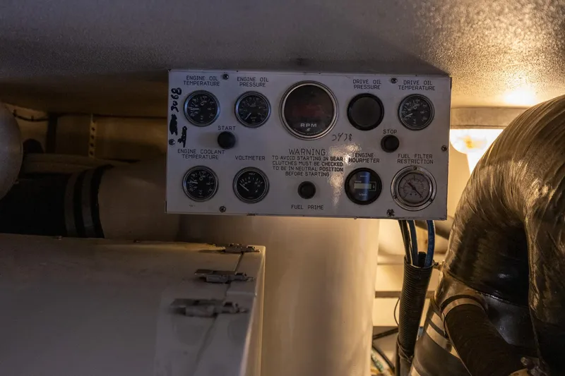 Slide: The Image of Engine control panel of a 1998 Viking 50 Convertible boat, displaying various gauges and warnings. - 52