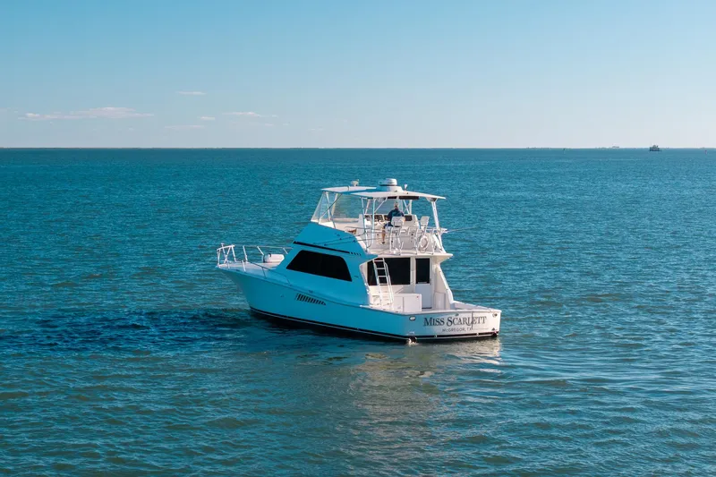 Slide: The Image of Viking 50 Convertible yacht from 1998 on open water, clear blue sky. - 53