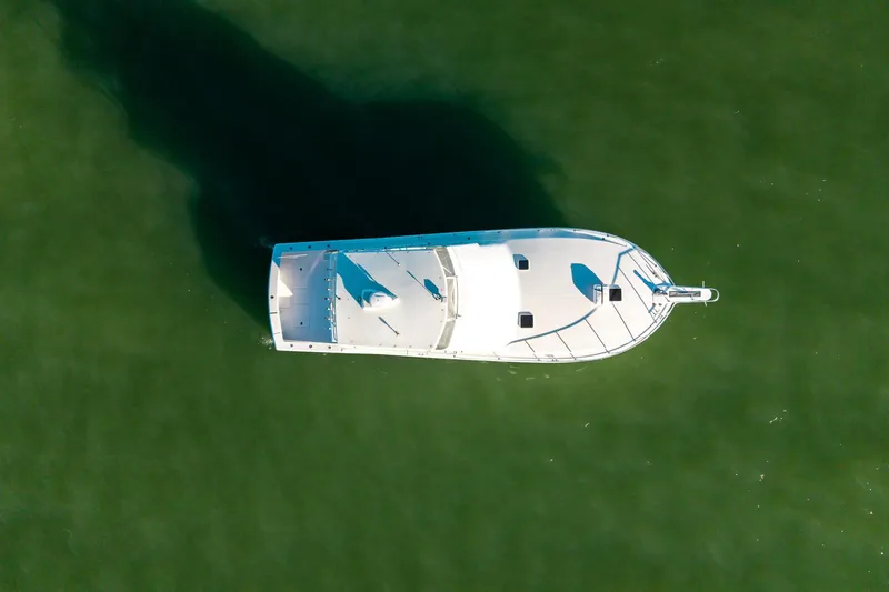 Slide: The Image of Aerial view of 1998 Viking 50 Convertible yacht on green water. - 58