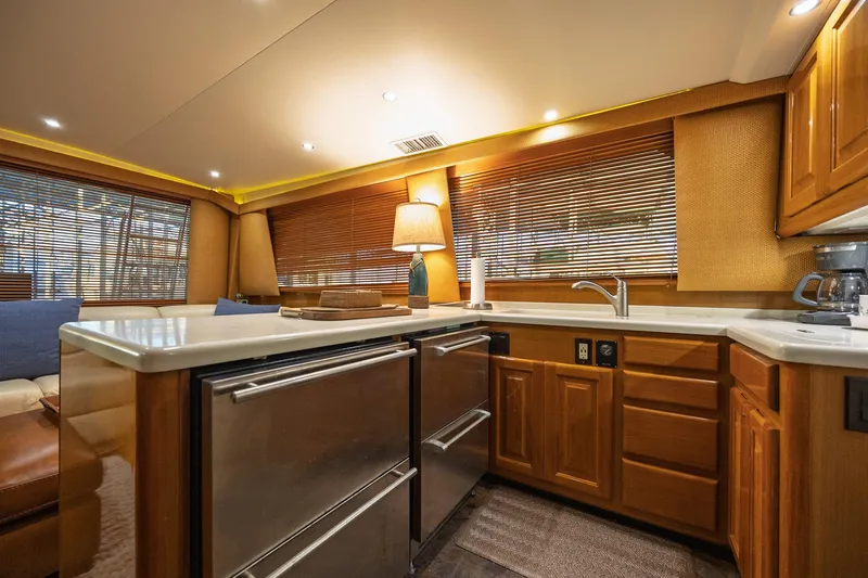 Slide: The Image of Luxurious kitchen interior of a 1998 Viking 50 Convertible yacht with wooden cabinetry. - 9