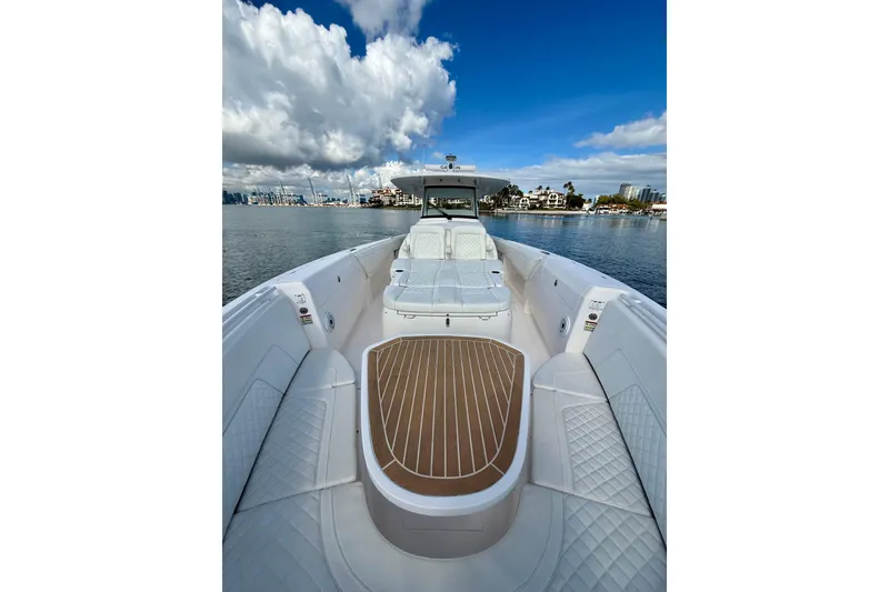 Slide: The Image of 2022 Intrepid 407 Nomad SE boat on calm water under a blue sky. - 12