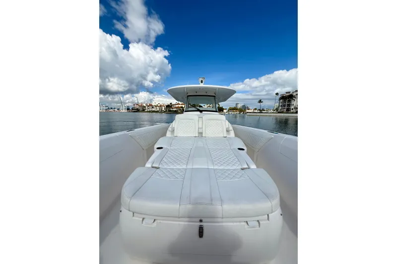 Slide: The Image of 2022 Intrepid 407 Nomad SE boat on calm water under blue sky. - 14