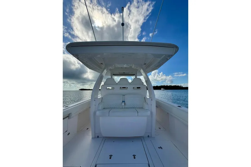 Slide: The Image of 2022 Intrepid 407 Nomad SE boat interior with seating, under a blue sky. - 21