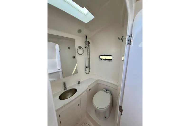 Slide: The Image of 2022 Intrepid 407 Nomad SE boat bathroom with sink, toilet, and shower. - 23