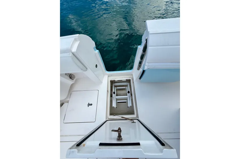 Slide: The Image of 2022 Intrepid 407 Nomad SE boat deck with storage compartments and ocean view. - 27