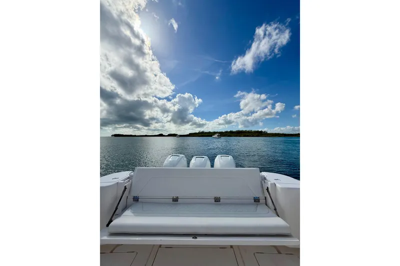 Slide: The Image of Intrepid 407 Nomad SE 2022 boat on calm water under a partly cloudy sky. - 8