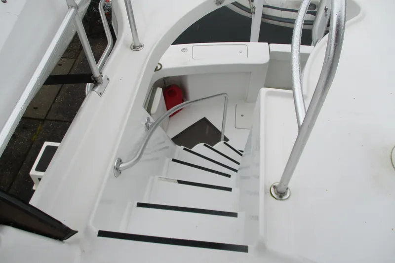 Slide: The Image of Staircase on 1997 Mainship 350 Trawler with metal railings and white steps. - 19