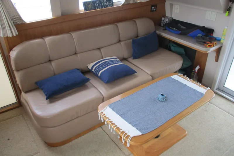 Slide: The Image of Interior of 1997 Mainship 350 Trawler with beige sofa and blue cushions. - 24