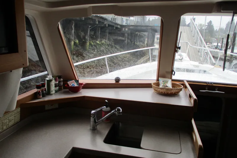 Slide: The Image of Interior view of 1997 Mainship 350 Trawler kitchen with sink and countertop. - 31