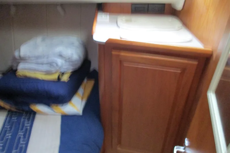 Slide: The Image of Interior of 1997 Mainship 350 Trawler with bedding and wooden cabinetry. - 35