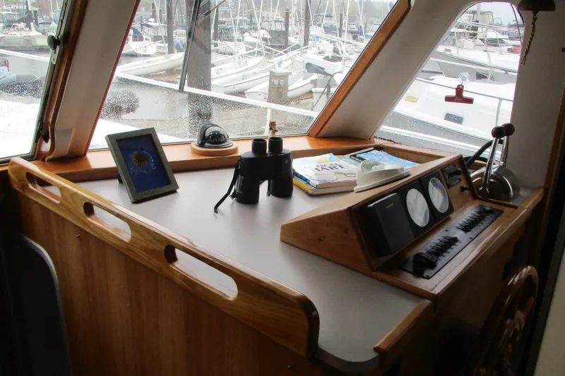 Slide: The Image of 1997 Mainship 350 Trawler helm with navigation equipment and marina view. - 46