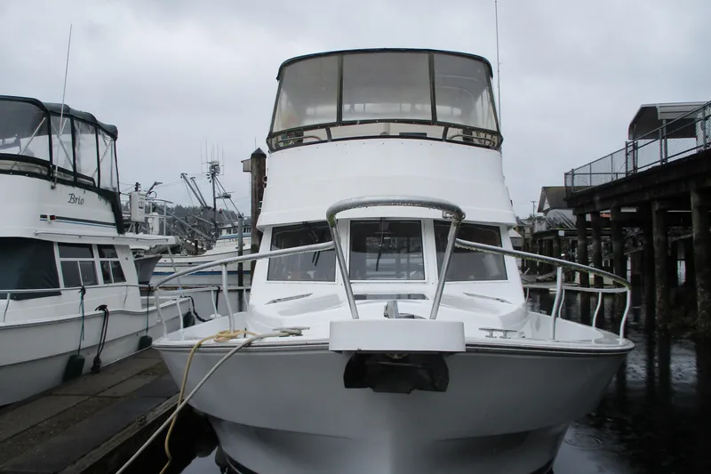 Slide: The Image of 1997 Mainship 350 Trawler docked at marina on a cloudy day. - 5