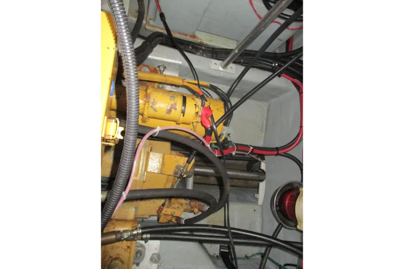Slide: The Image of Engine room of 1997 Mainship 350 Trawler with visible machinery and wiring. - 50