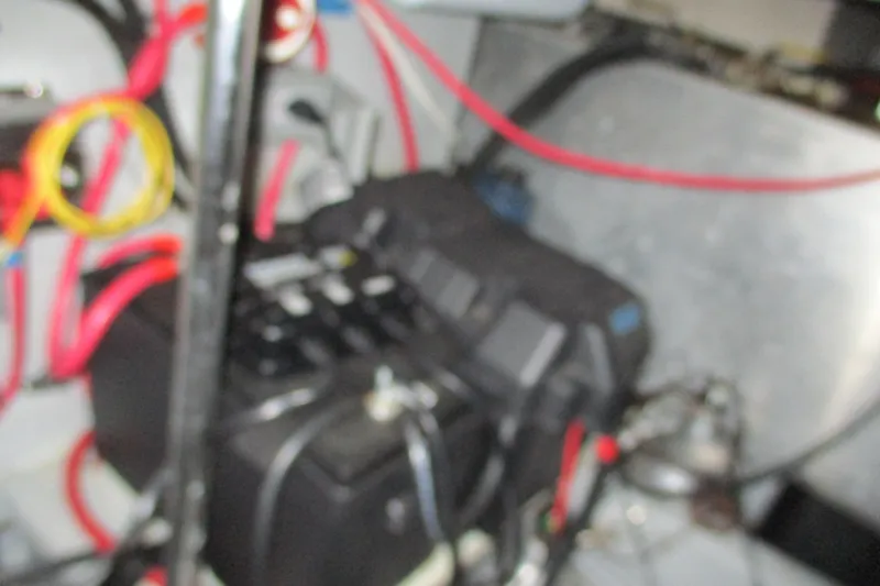 Slide: The Image of Blurry engine room of 1997 Mainship 350 Trawler with visible wiring and components. - 52