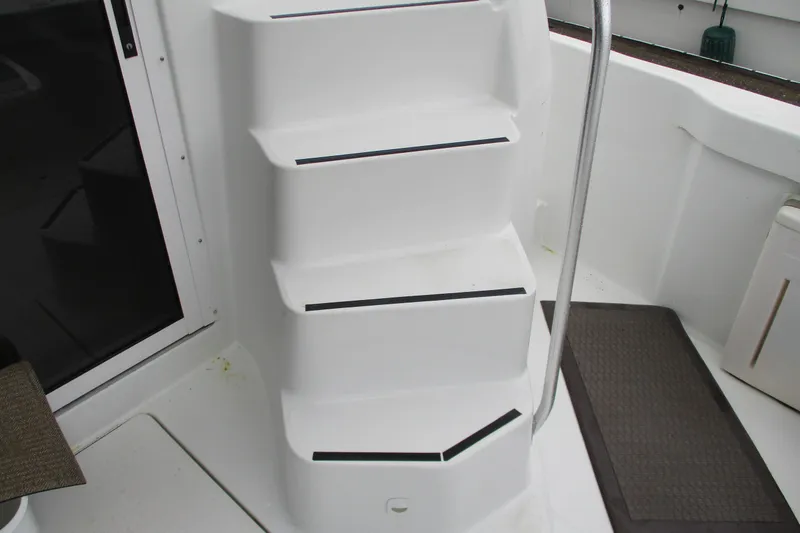 Slide: The Image of White steps with black grip strips on a 1997 Mainship 350 Trawler boat. - 53