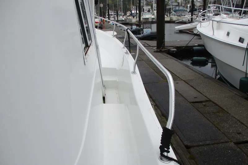 Slide: The Image of Side view of a 1997 Mainship 350 Trawler docked at a marina. - 56