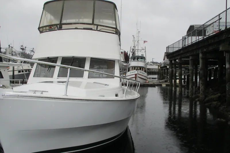 Slide: The Image of 1997 Mainship 350 Trawler docked in a marina on a cloudy day. - 6