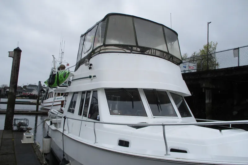 Slide: The Image of 1997 Mainship 350 Trawler docked at marina on a cloudy day. - 8