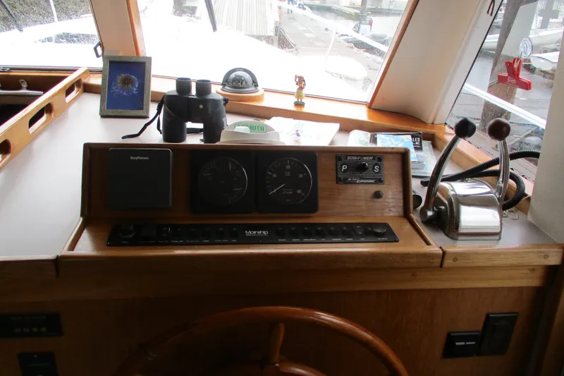 Slide: The Image of 1997 Mainship 350 Trawler helm with controls, gauges, and navigation equipment. - 21