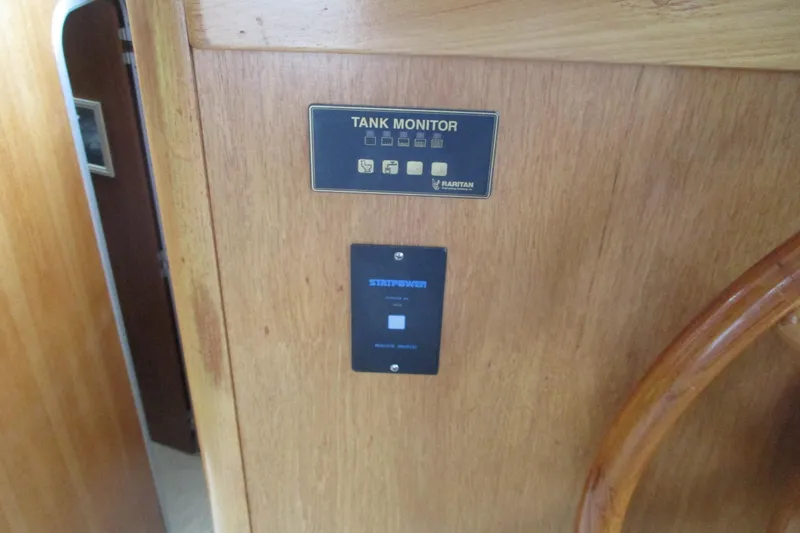 Slide: The Image of Tank monitor panel on 1997 Mainship 350 Trawler, featuring Raritan and Ship Power controls. - 22