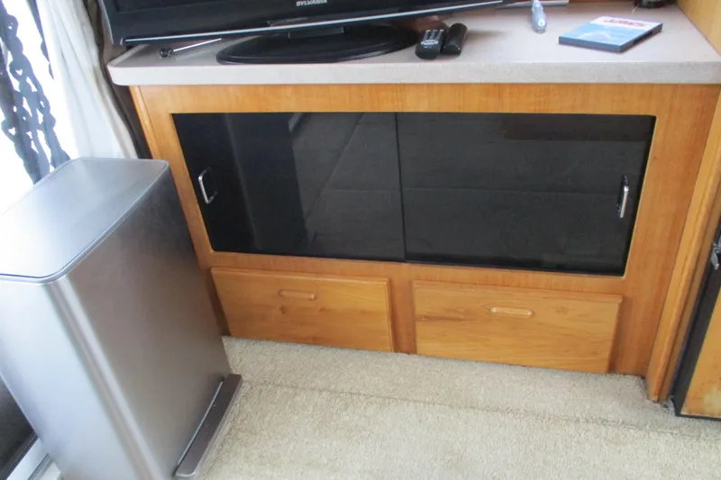 Slide: The Image of Interior of 1997 Mainship 350 Trawler with wooden cabinet and modern appliances. - 26